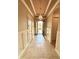 Grand foyer featuring tile floors, wainscoting, and a statement chandelier at 11489 Bitola Dr, Odessa, FL 33556