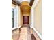Inviting front entryway with arched alcove, decorative stone accents, and a solid wood door with sidelights at 11489 Bitola Dr, Odessa, FL 33556