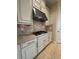 Close-up of kitchen gas cooktop with custom vent hood and granite countertops at 11489 Bitola Dr, Odessa, FL 33556