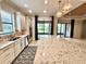 Bright and airy kitchen boasts modern appliances and overlooks an inviting outdoor space at 11489 Bitola Dr, Odessa, FL 33556