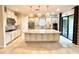 Spacious kitchen featuring a large island, stainless appliances, and elegant pendant lighting at 11489 Bitola Dr, Odessa, FL 33556