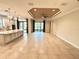 Expansive living room with high tray ceiling and large sliding glass doors to the outdoors at 11489 Bitola Dr, Odessa, FL 33556