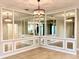 Open-concept living area with tiled floors and decorative mirrors create a light and airy atmosphere at 11489 Bitola Dr, Odessa, FL 33556