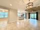Spacious open-concept living area featuring tile flooring and views of the kitchen and outdoor space at 11489 Bitola Dr, Odessa, FL 33556