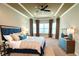 Comfortable main bedroom featuring a tray ceiling, fan, and plenty of natural light at 11489 Bitola Dr, Odessa, FL 33556