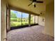 Screened patio offers brick flooring with an outdoor view and ceiling fans at 11489 Bitola Dr, Odessa, FL 33556