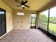 Screened-in patio with brick flooring, ceiling fan, and view of the backyard at 11489 Bitola Dr, Odessa, FL 33556