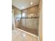 Large shower with mosaic tile and glass doors in neutral color bath at 11489 Bitola Dr, Odessa, FL 33556
