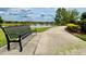 Scenic walking path along the lake with a bench, offering a tranquil spot to relax and enjoy nature at 11489 Bitola Dr, Odessa, FL 33556