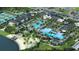 Aerial view of community pool area with palm trees, seating, and a beach area by the lake at 11510 Myakka Blue Dr, Venice, FL 34293