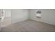 Comfortable bedroom featuring soft carpet, ample natural light from a large window, and neutral tones at 116 Leisure Pl, Rotonda West, FL 33947