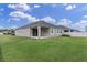 The backyard features a well-maintained lawn and a covered patio at 11626 Blue Woods Dr, Riverview, FL 33569