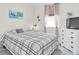Bedroom features a black and white patterned bed with a window and sheer curtains at 11626 Blue Woods Dr, Riverview, FL 33569