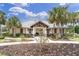 Community clubhouse featuring lush landscaping and walking paths at 11626 Blue Woods Dr, Riverview, FL 33569