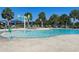 Community pool with lounge chairs, shade umbrellas, and splash area at 11626 Blue Woods Dr, Riverview, FL 33569