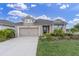 Charming single-Gathering home with well-maintained landscaping and a spacious driveway at 11626 Blue Woods Dr, Riverview, FL 33569