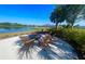 Inviting outdoor area with a fire pit and comfortable chairs overlooking a serene lake at 11626 Blue Woods Dr, Riverview, FL 33569