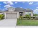 Charming single-story home featuring a two-car garage, landscaped yard, and inviting entrance at 11626 Blue Woods Dr, Riverview, FL 33569