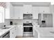 Well-lit kitchen features modern appliances, white cabinets, and a stylish backsplash at 11626 Blue Woods Dr, Riverview, FL 33569