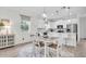Bright eat-in kitchen with white cabinets, stainless steel appliances, and pendant lighting at 11626 Blue Woods Dr, Riverview, FL 33569