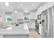 Bright kitchen featuring white cabinets, stainless steel appliances, and a large island with seating at 11626 Blue Woods Dr, Riverview, FL 33569