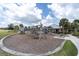Community playground offering swings, slides, picnic tables, and a charming playhouse for  at 11626 Blue Woods Dr, Riverview, FL 33569