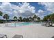 Large community pool with comfortable lounge chairs and splash pad, all surrounded by palm trees at 11626 Blue Woods Dr, Riverview, FL 33569