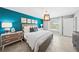 A bedroom featuring an accent wall, a pendant light, and neutral furnishings at 118 Leisure Pl, Rotonda West, FL 33947