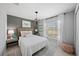 Comfortable bedroom with a stylish light fixture, wicker accents, and bright natural light at 118 Leisure Pl, Rotonda West, FL 33947