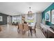 Elegant dining room with stylish decor, modern light fixtures, and views of the backyard at 118 Leisure Pl, Rotonda West, FL 33947