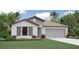 Charming single-Gathering home with a two-car garage, manicured lawn, and lush landscaping at 118 Leisure Pl, Rotonda West, FL 33947