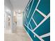 Bright hallway featuring a modern geometric wall design leading to the front door at 118 Leisure Pl, Rotonda West, FL 33947