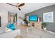 Inviting living room with stylish decor, ceiling fan, and gray accent wall at 118 Leisure Pl, Rotonda West, FL 33947