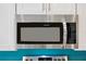 Close up of a stainless steel Frigidaire microwave over a kitchen range at 118 Leisure Pl, Rotonda West, FL 33947