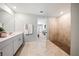 Bright bathroom with a walk-in shower and open doorway to the bedroom at 119 Leisure Pl, Rotonda West, FL 33947
