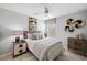 Comfortable bedroom with a ceiling fan, decorative wall art, and a cozy bed with stylish bedside tables at 119 Leisure Pl, Rotonda West, FL 33947