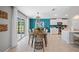 Dining area with modern table and chairs connecting the kitchen and living space at 119 Leisure Pl, Rotonda West, FL 33947