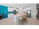 Bright kitchen with white cabinets, stainless steel appliances, and a center island with bar seating, perfect for entertaining at 119 Leisure Pl, Rotonda West, FL 33947