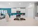 Modern kitchen featuring white cabinets, stainless steel appliances, and a large island with quartz countertop at 119 Leisure Pl, Rotonda West, FL 33947