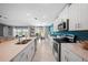 Open concept kitchen with stainless steel appliances, white cabinetry, and dining area at 119 Leisure Pl, Rotonda West, FL 33947