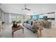 Open-concept living space with kitchen island, dining area, and comfortable seating, offering panoramic views at 119 Leisure Pl, Rotonda West, FL 33947