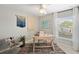 Bright home office space with a modern desk, unique decor, and plenty of natural light from a large window at 119 Leisure Pl, Rotonda West, FL 33947