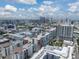 Aerial view of a cityscape with multiple condo buildings, highways, and skyscrapers against a partly cloudy sky at 1208 E Kennedy Blvd # 914, Tampa, FL 33602