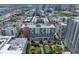 An aerial view of a dense urban area with condos, commercial buildings, parks, and waterways under a cloudy sky at 1208 E Kennedy Blvd # 914, Tampa, FL 33602