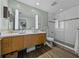 A luxurious bathroom featuring a double sink vanity, a walk-in shower, and modern fixtures at 1208 E Kennedy Blvd # 914, Tampa, FL 33602