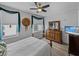 This bedroom boasts an ornate dresser, modern ceiling fan, and beautiful window views with curtains at 1208 E Kennedy Blvd # 914, Tampa, FL 33602