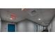 Hallway in a building featuring a blue exit door, neutral-toned walls, carpeted floor, and recessed lighting at 1208 E Kennedy Blvd # 914, Tampa, FL 33602