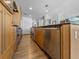 Kitchen featuring modern stainless steel appliances, wood cabinets, and an island with bar seating at 1208 E Kennedy Blvd # 914, Tampa, FL 33602