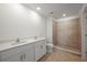 Modern bathroom with dual sinks, tiled shower, and stylish fixtures at 1454 Atlas St, Port Charlotte, FL 33952