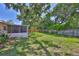 Large backyard features a screened lanai and mature trees at 1500 Robinson N Dr, St Petersburg, FL 33710